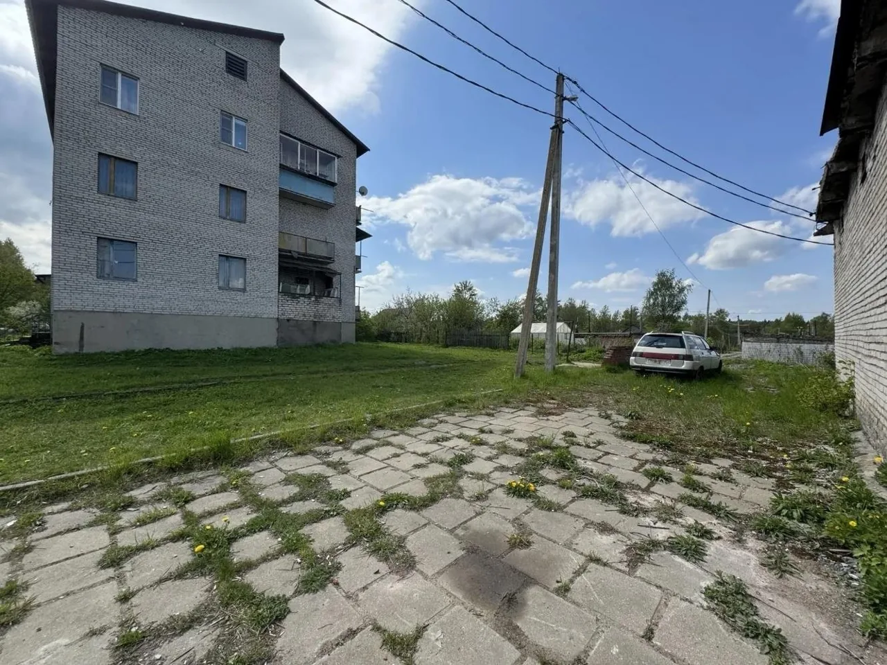 View looking south-west: the site between a residential building and an access road
