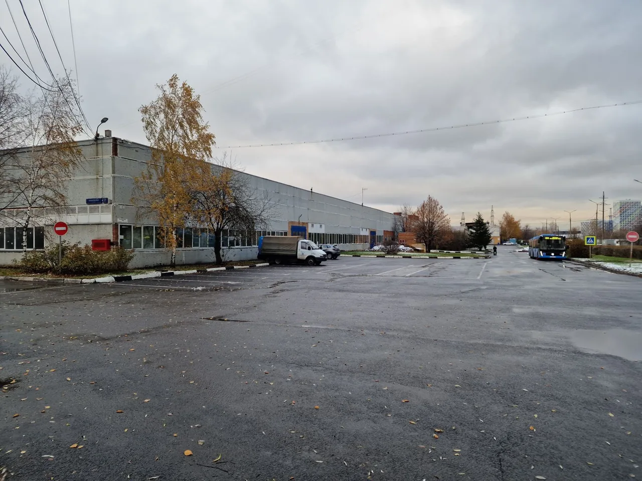 Operating industrial site on Bibirevskaya St prior to works: single-storey building and access road